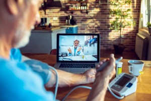 senior-man-consulting-with-his-doctor-online-300w