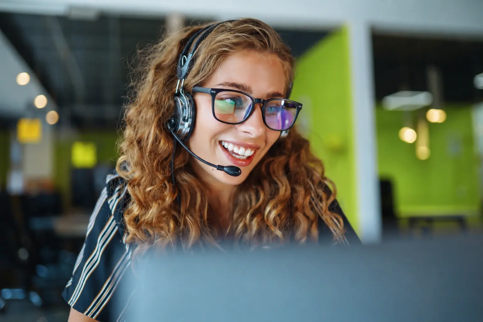 Kajeet customer support rep with headset in office - photo
