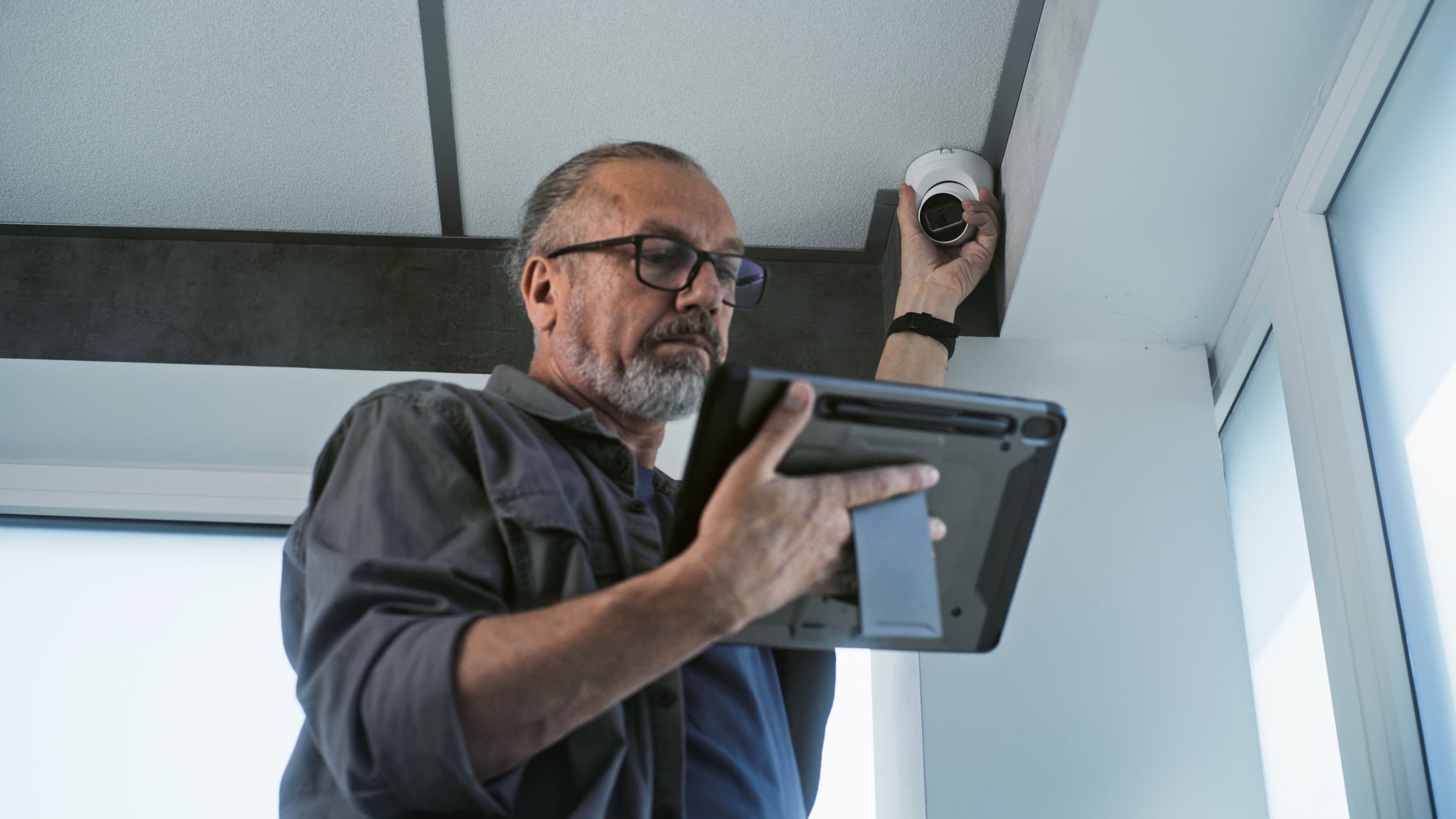 Employee installing security camera
