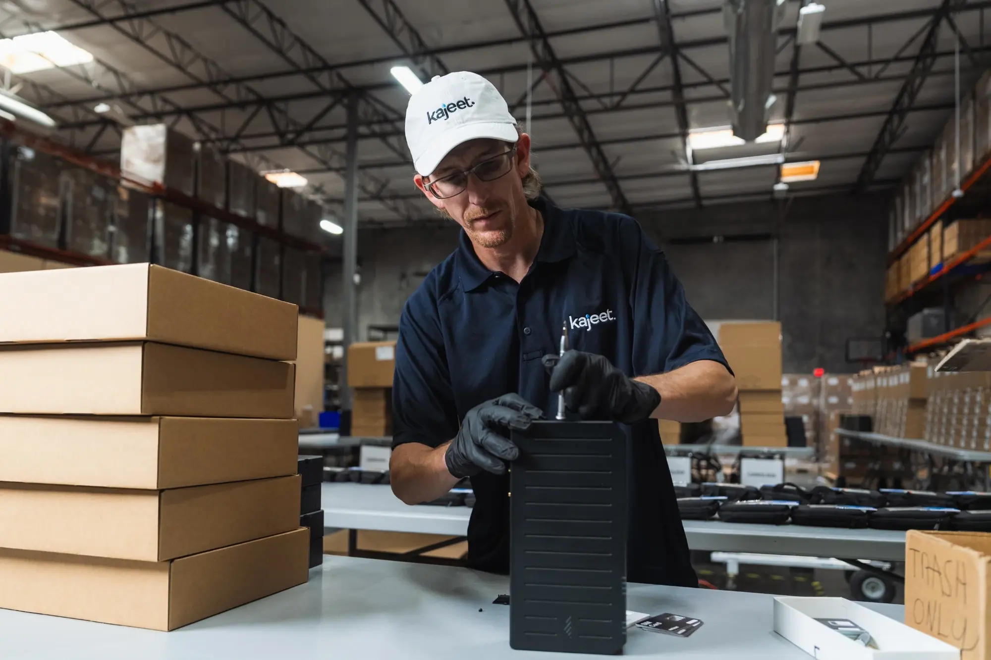 Kajeet connectivity technician installing router SIM card - photo