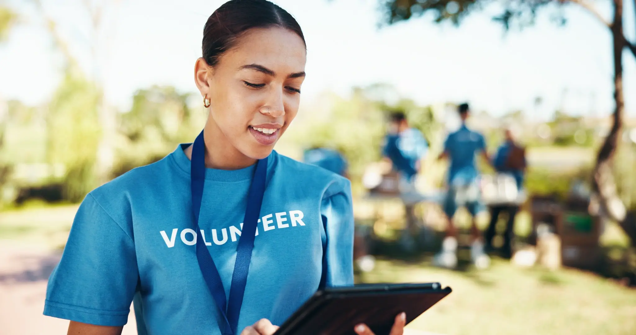 Volunteer outside with 5G cellular tablet - photo